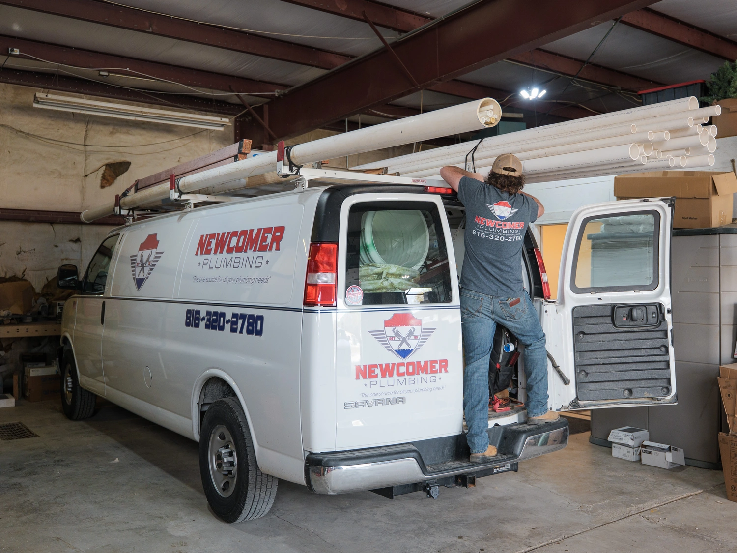 Man holding a white towel, standing with a neutral expression in a well-lit indoor setting.